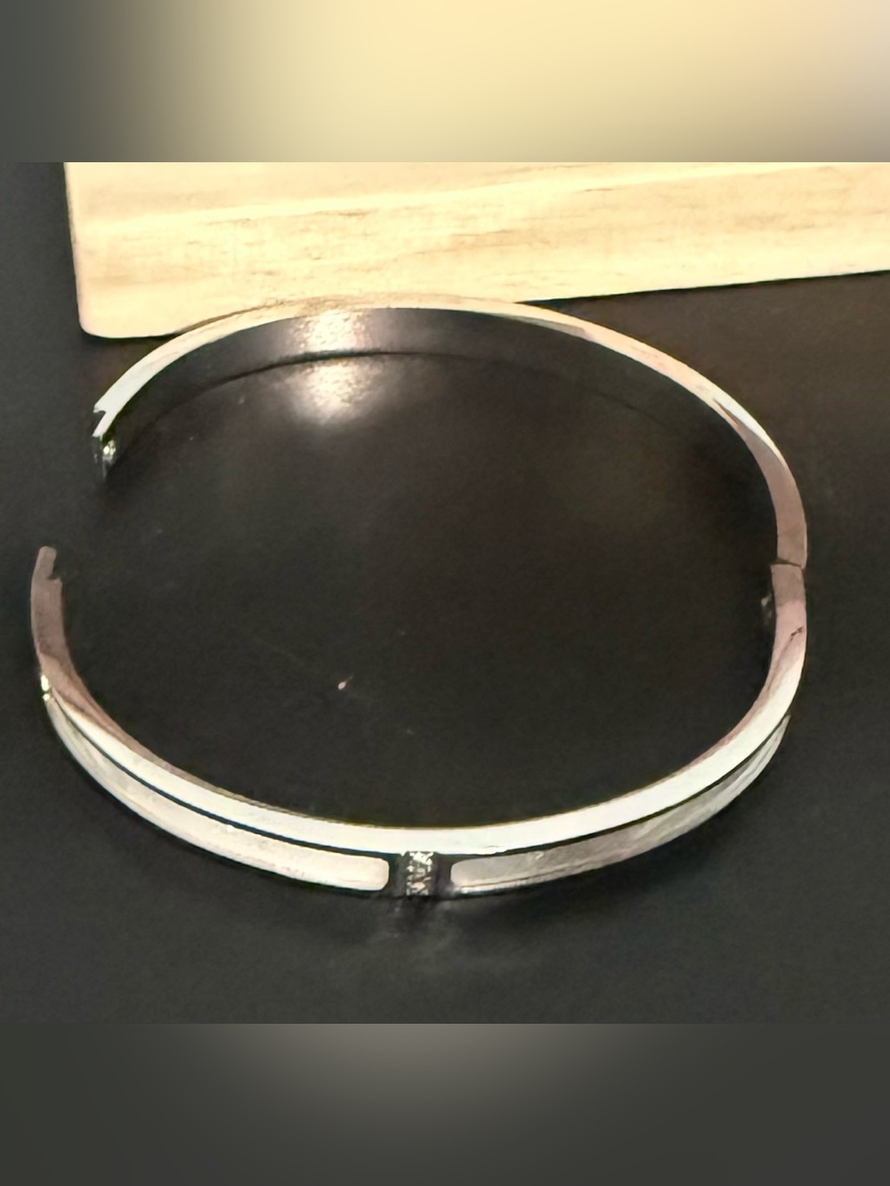 Bangle bracelet Silver tone with white inlay and stones.